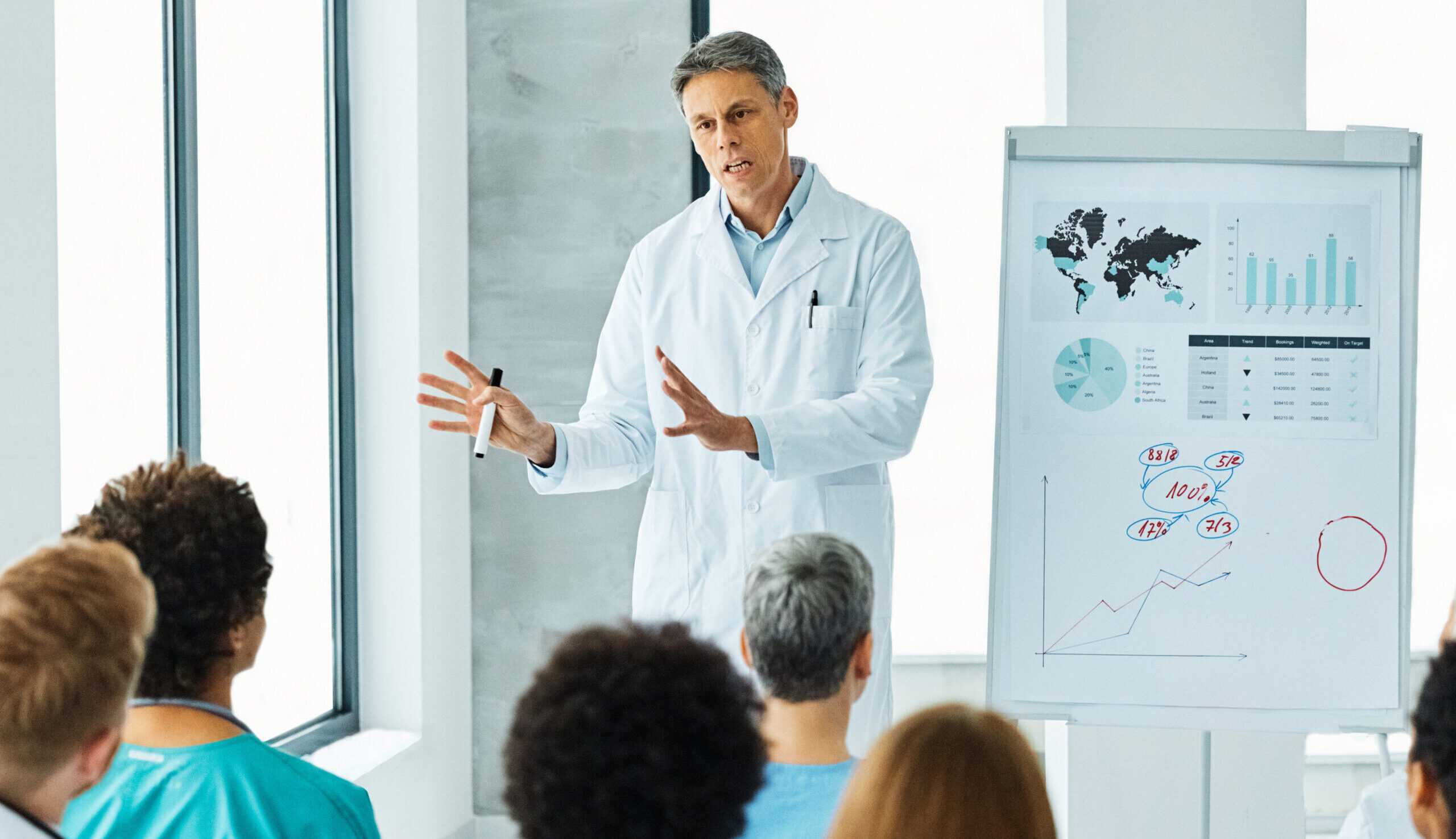 Portrait of a young doctor teaching on a seminar in a board room or during an educational class at convention center