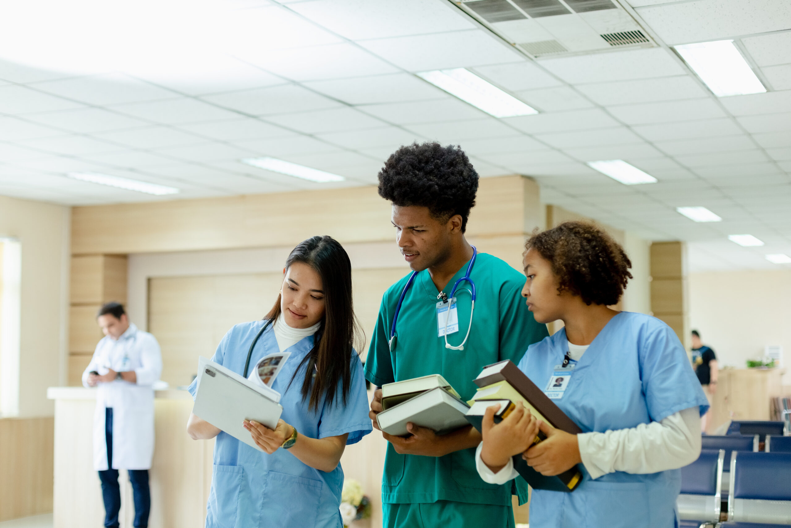 Group of medical student holding book walking front classroom in hospital university. education and learning medical concept. Study paramedics specialists.